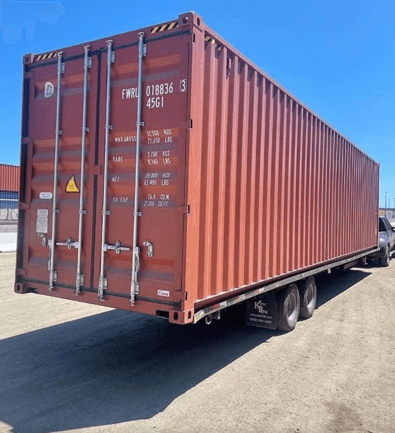 A new 40ft shipping container in dark blue standing on level ground