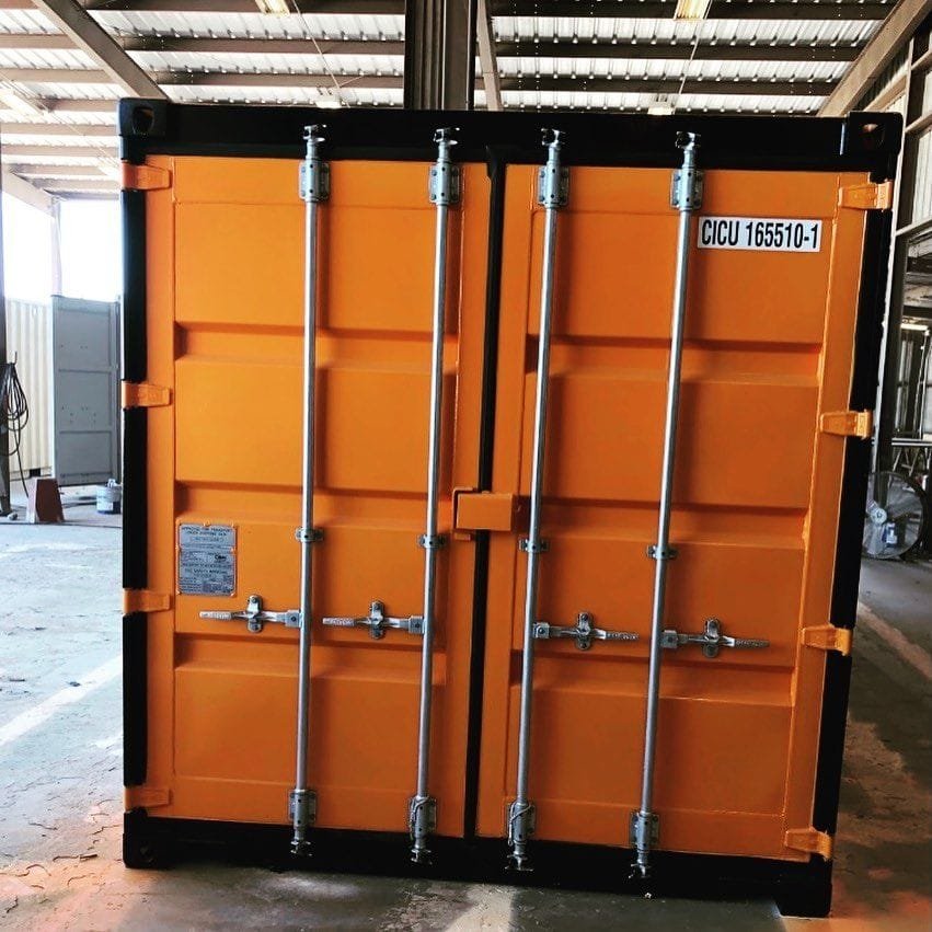 Close-up of shipping container door gear showing lock rods, cams and keepers
